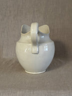 The washstand jug seen from above, showing the shaped lip and the handle