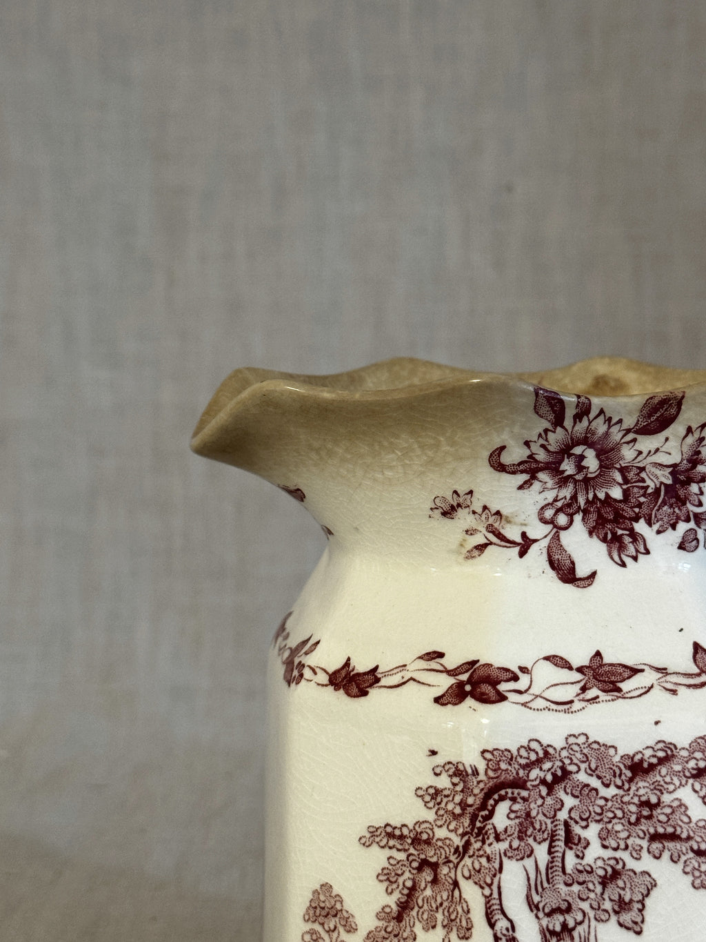 Detail of the rim showing the deep warm staining gathered around the neck