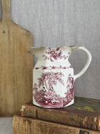 Vintage Masons Ironstone Watteau red transferware jug shown on a bread board and antique books for size reference