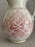 Close detail of the Colomba transfer pattern showing birds among branches on crazed cream faience