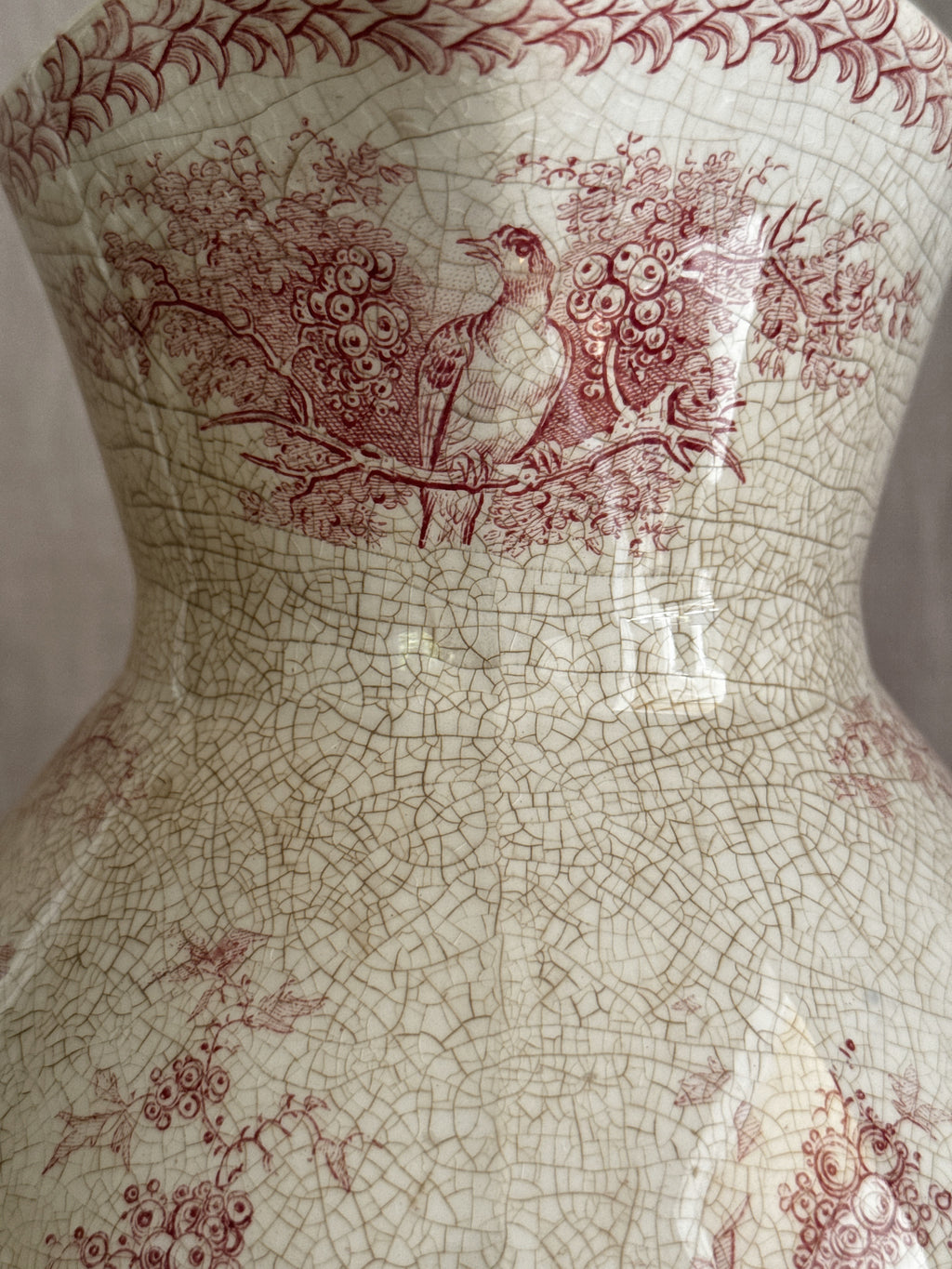 Close view of the spout and rim showing the crazed glaze and soft red border