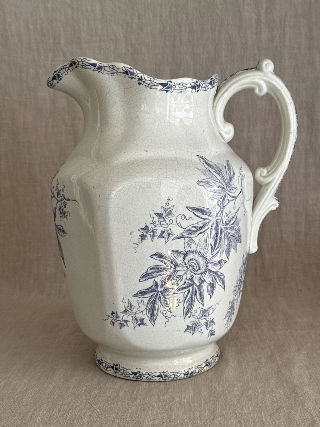 Side view of the Wasmuel jug showing the purple passionflower transfer on cream earthenware