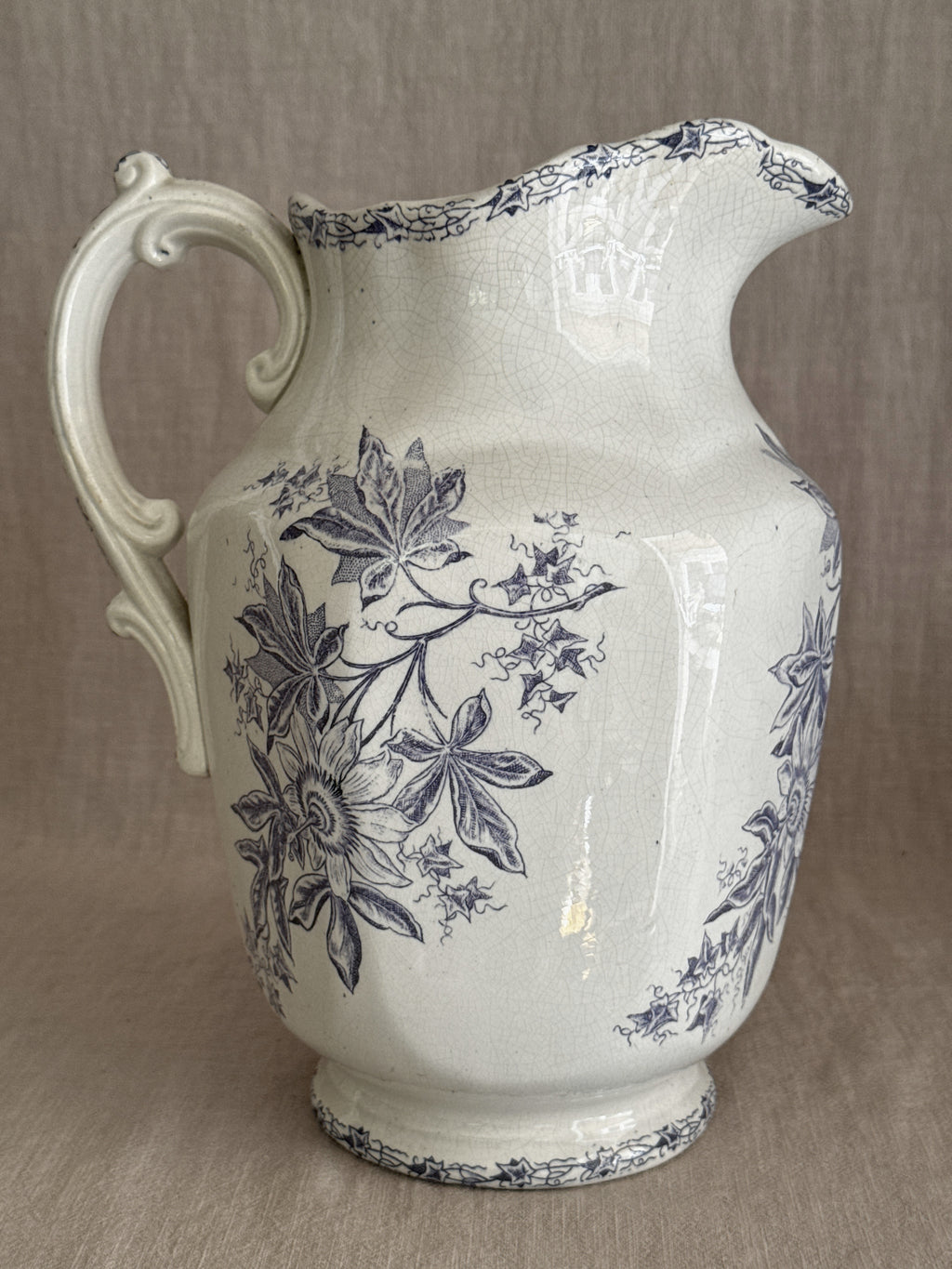 The jug seen from the opposite side with the scrolled handle in profile