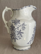 The jug seen from the opposite side with the scrolled handle in profile