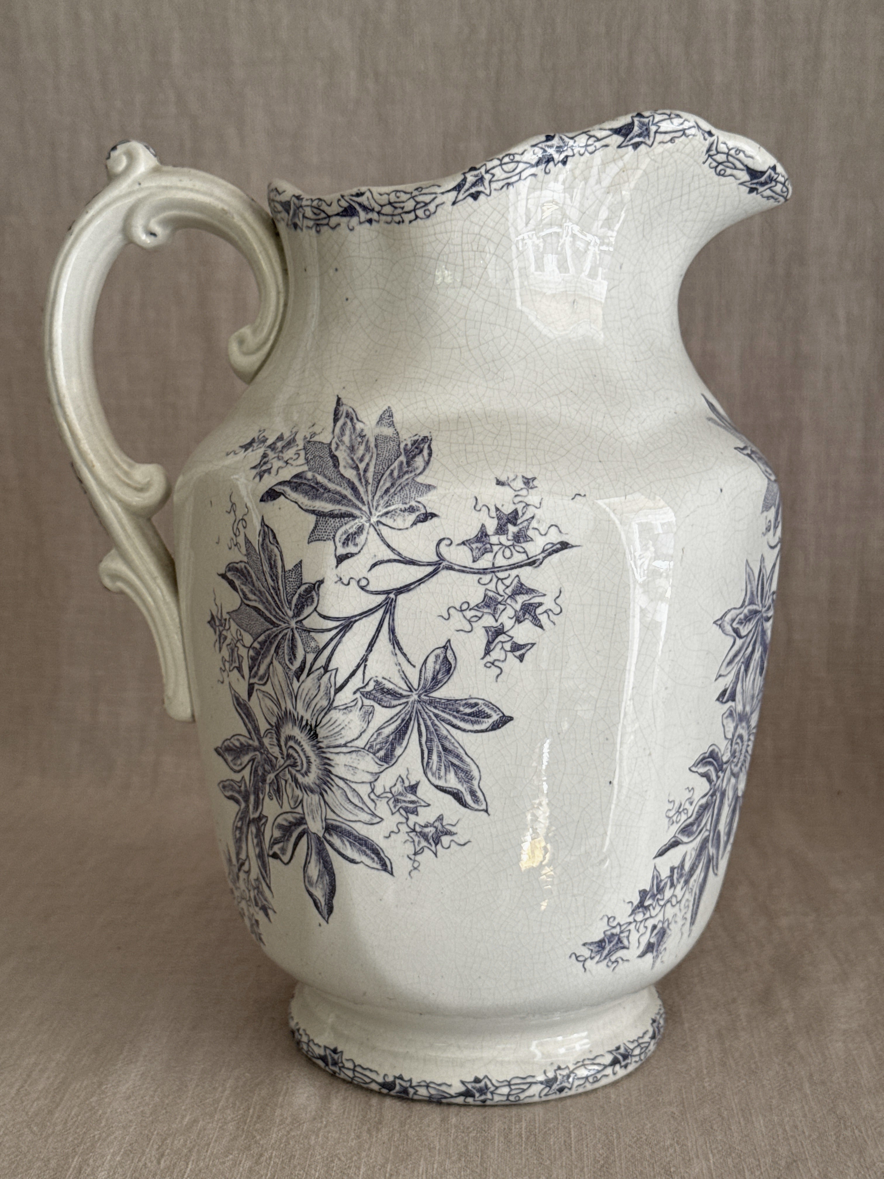 The jug seen from the opposite side with the scrolled handle in profile