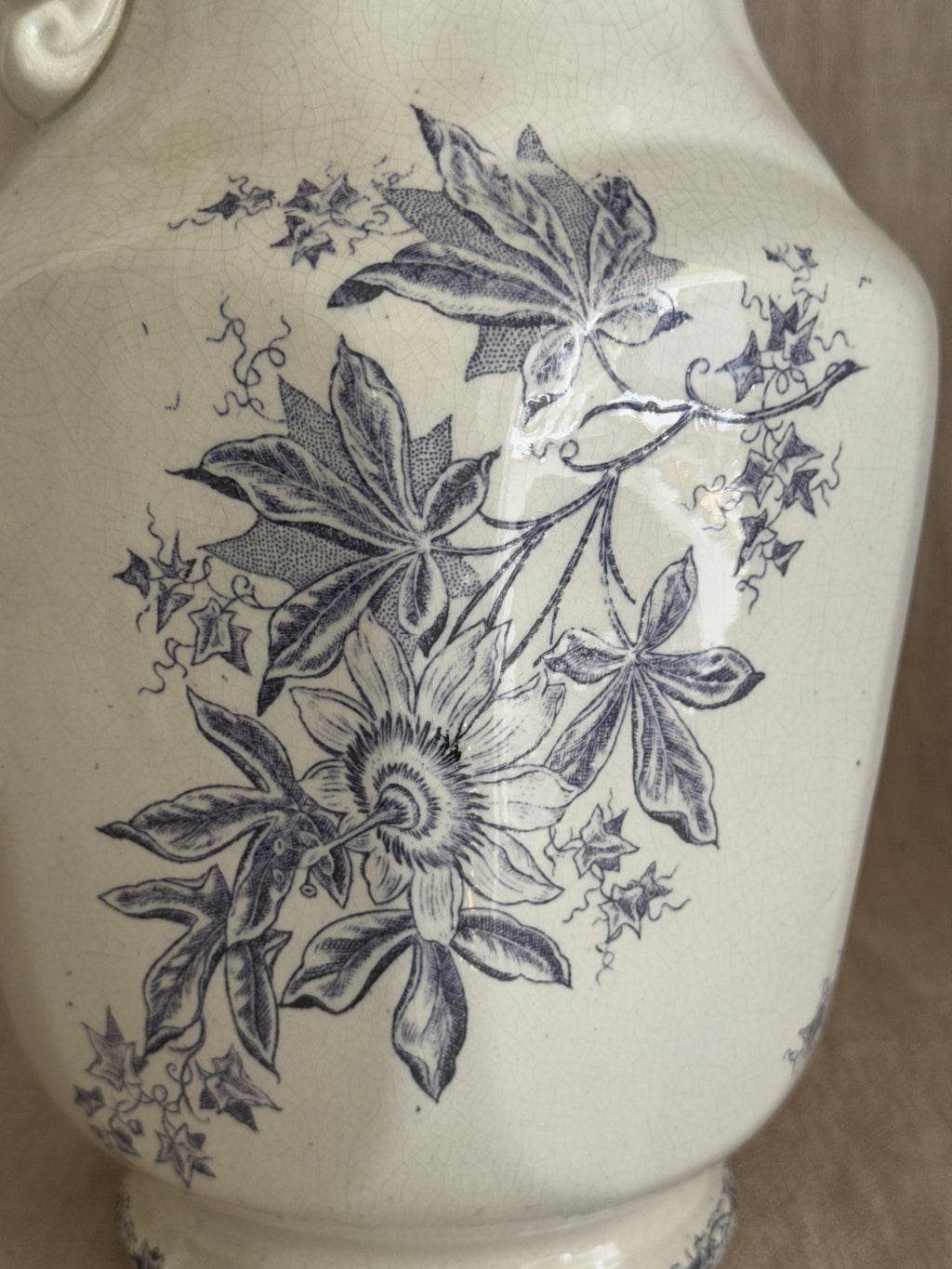 Close detail of the passionflower transfer pattern in purple on the crazed cream glaze