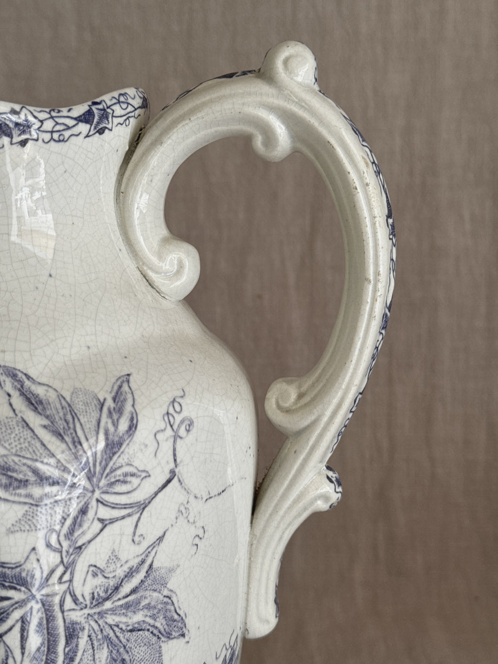 Detail of the scrolled rocaille handle in cream earthenware