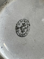 Base of the jug showing the round Opaque de Wasmuel mark with a flower at its centre
