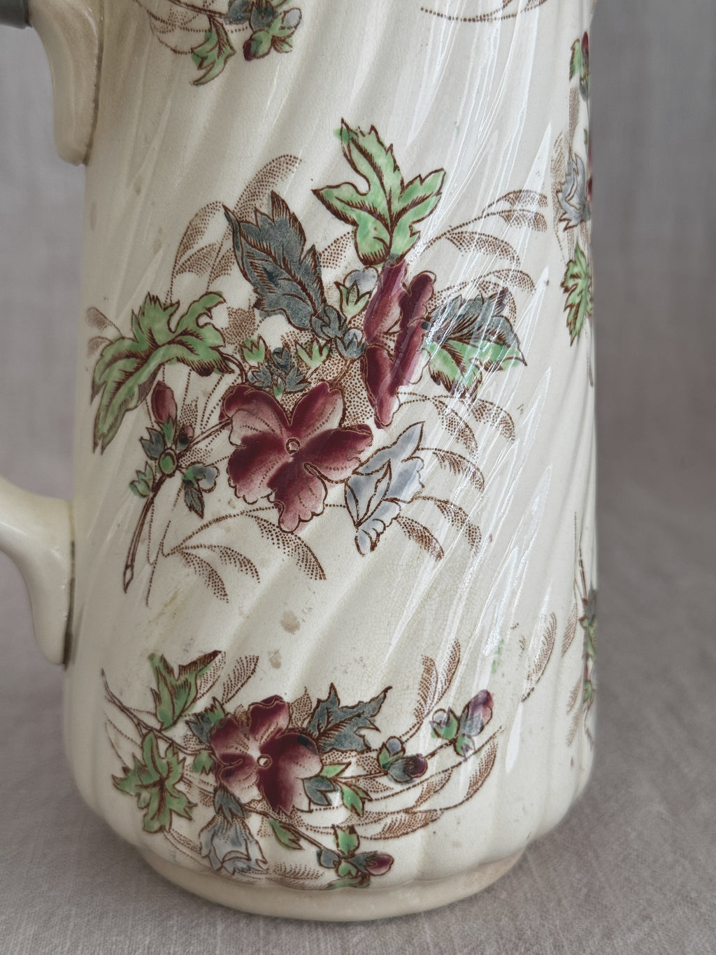 Close detail of the multicoloured floral transfer on the ribbed cream body