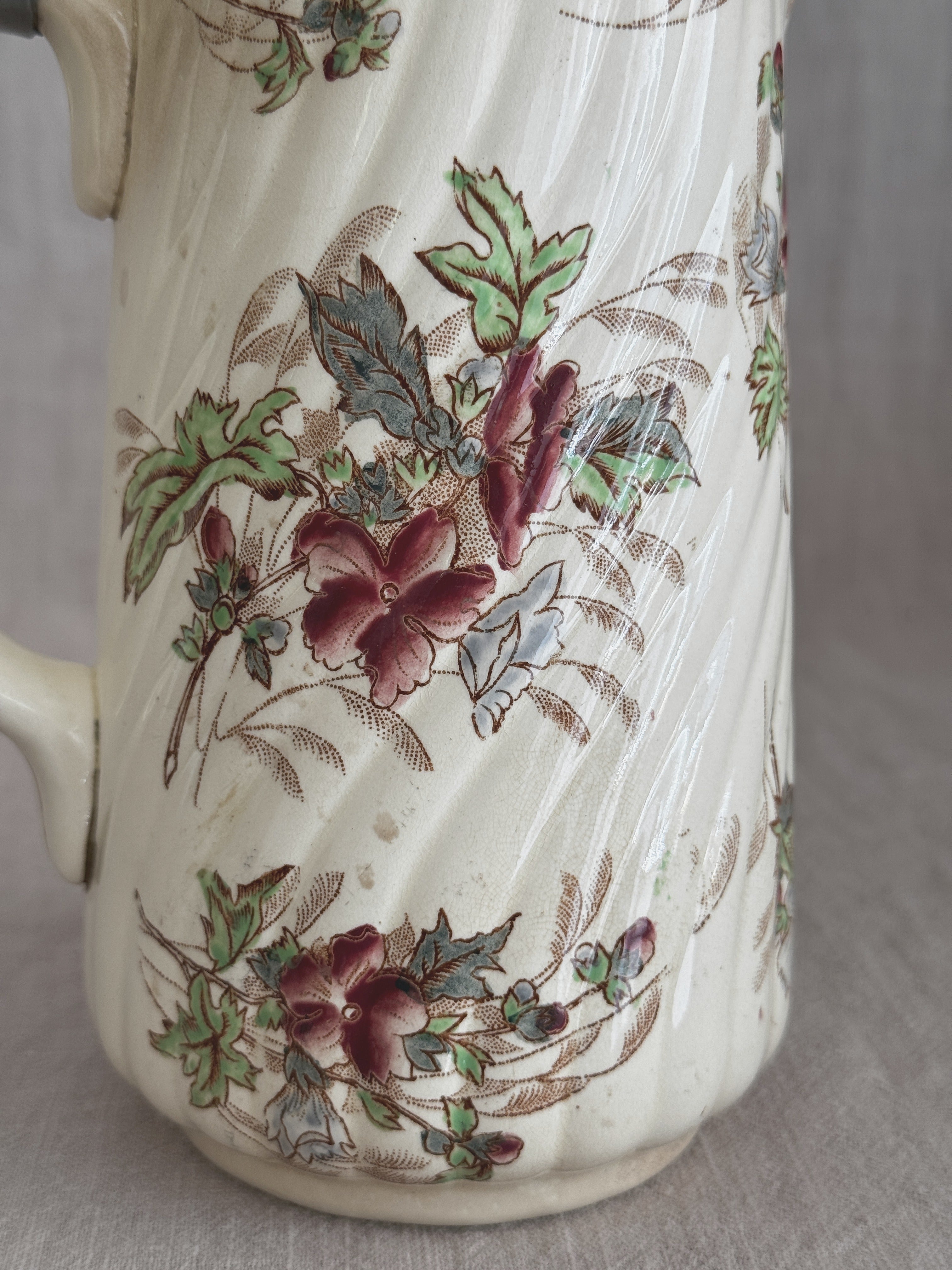 Close detail of the multicoloured floral transfer on the ribbed cream body