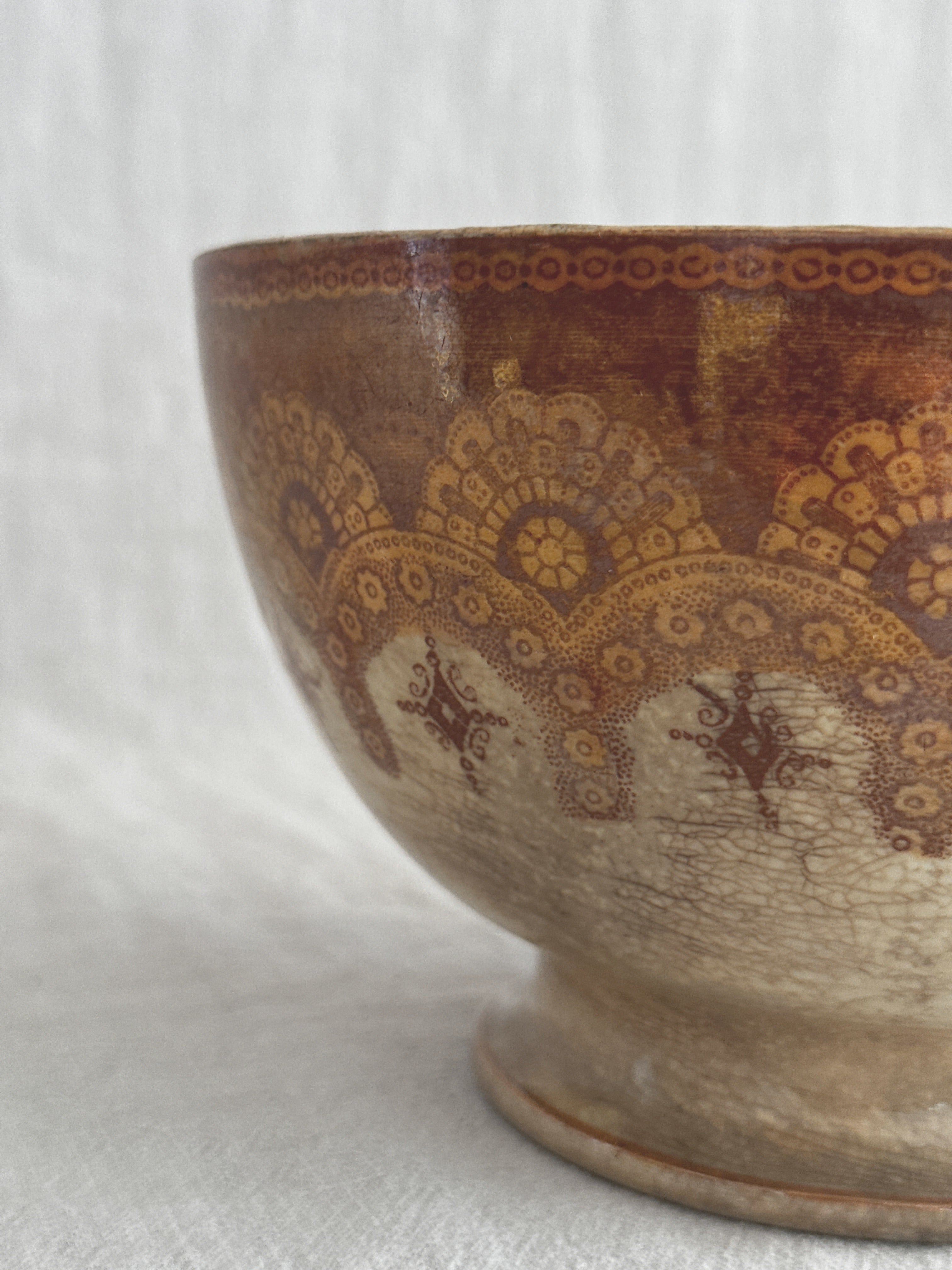 Angled view of the bowl showing the pedestal foot and the lustre surface