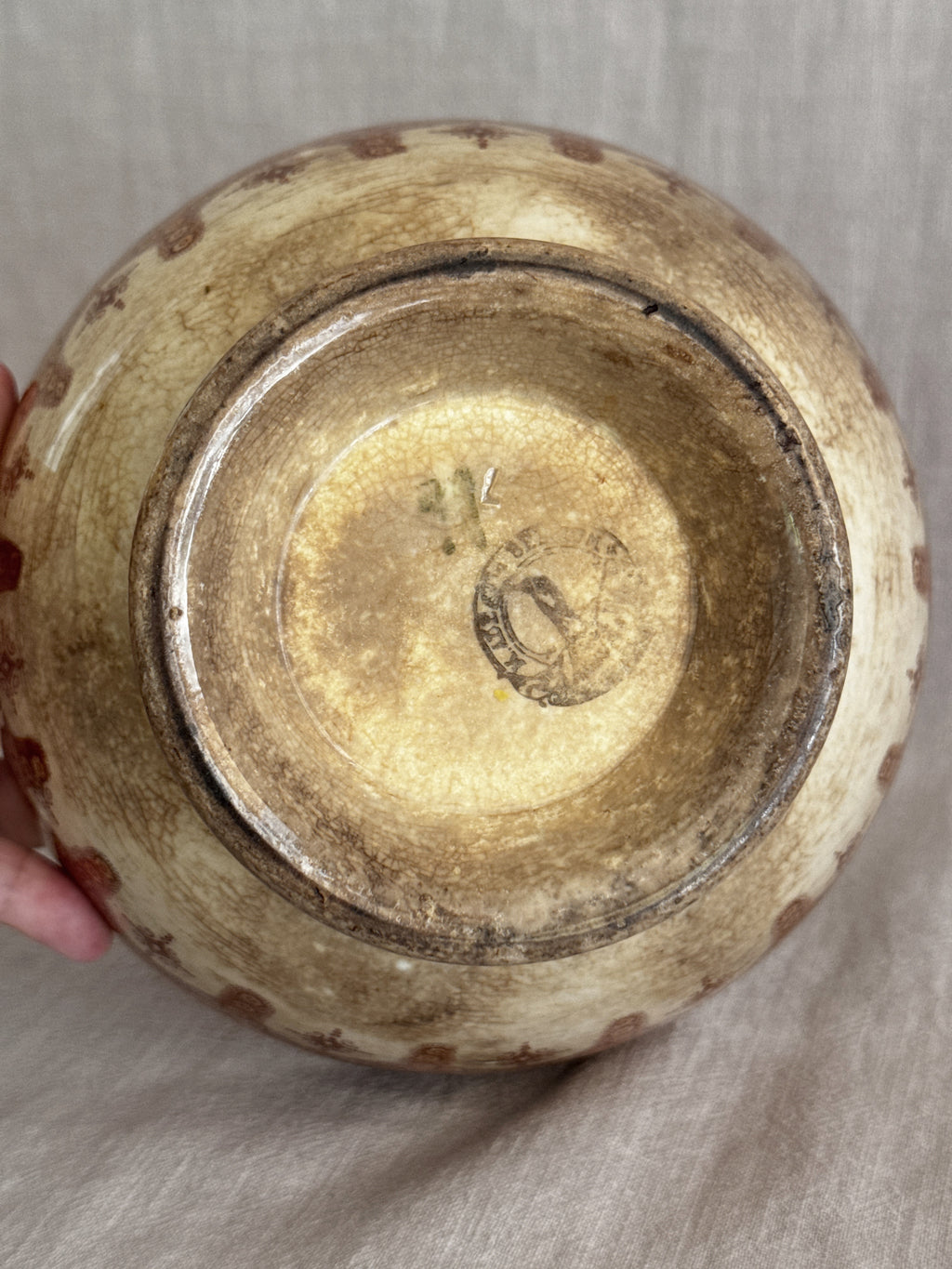 Close view of the base showing the indistinct circular mark and worn glaze