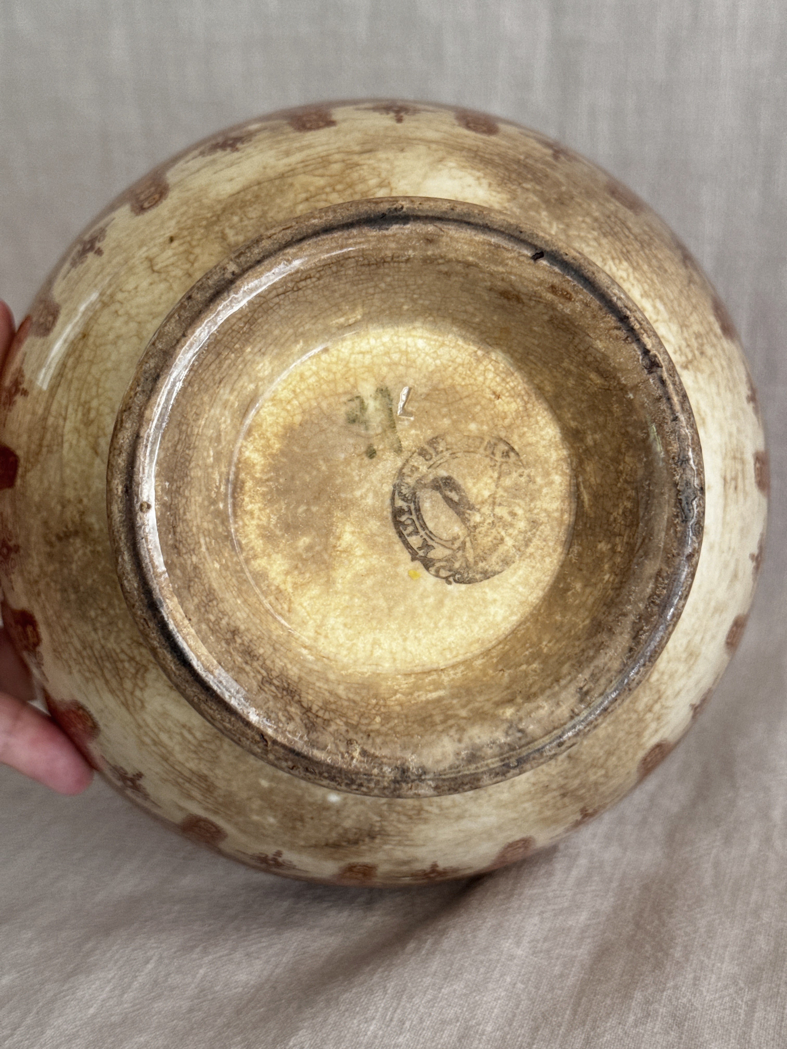 Close view of the base showing the indistinct circular mark and worn glaze