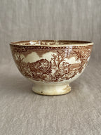 Underside angle of the footed bowl showing the pedestal foot and printed band
