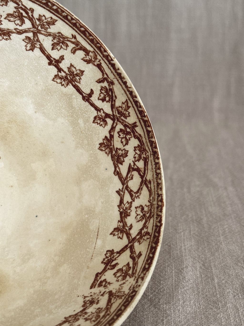 Close view of the interior showing the leaf border and heavy crazing in the cream glaze