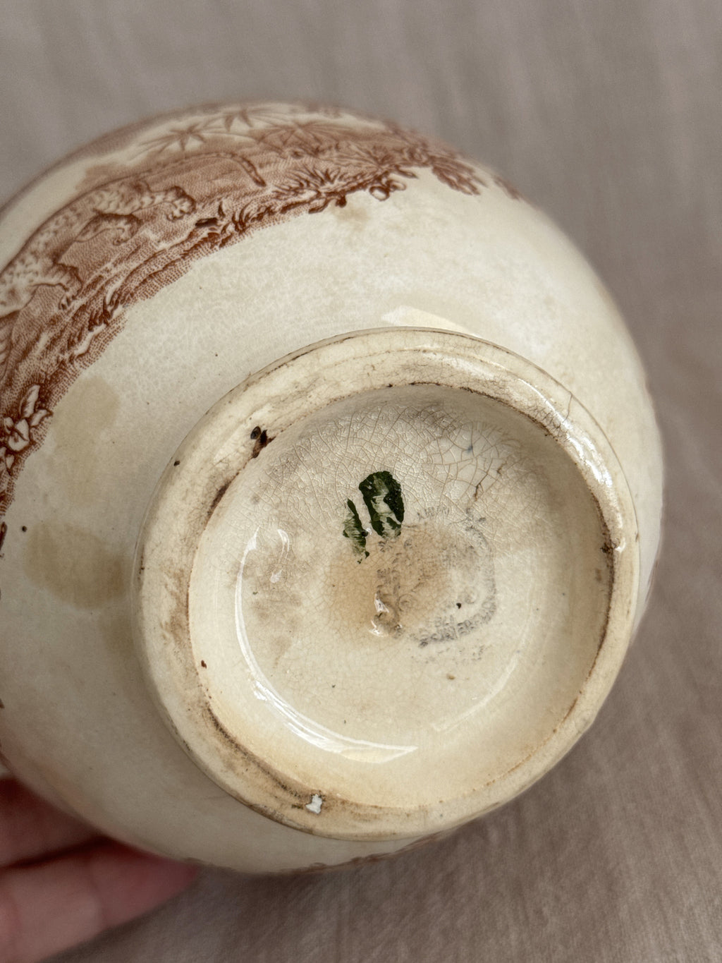 Base of the bowl held in hand, showing the blurred green printed mark