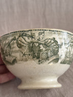 Side view of the green transferware bowl showing the aeroplane pattern and pedestal foot