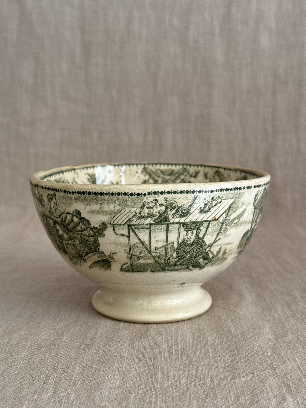 Underside angle of the footed bowl showing the pedestal foot and green print
