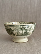Underside angle of the footed bowl showing the pedestal foot and green print