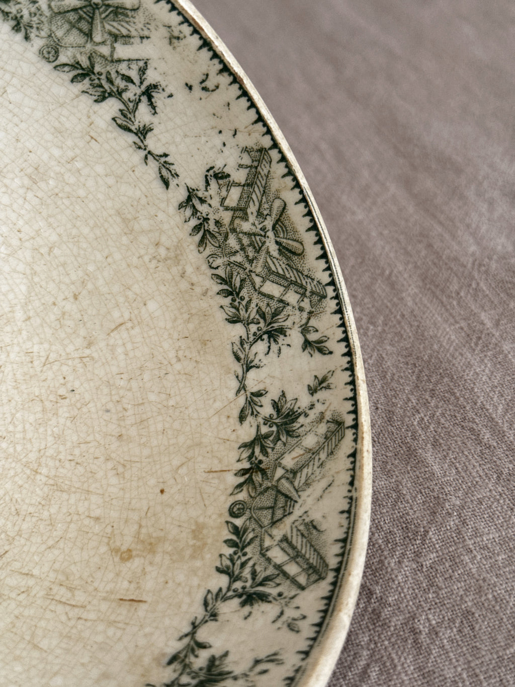 Close view of the interior rim border and the crazing in the cream glaze