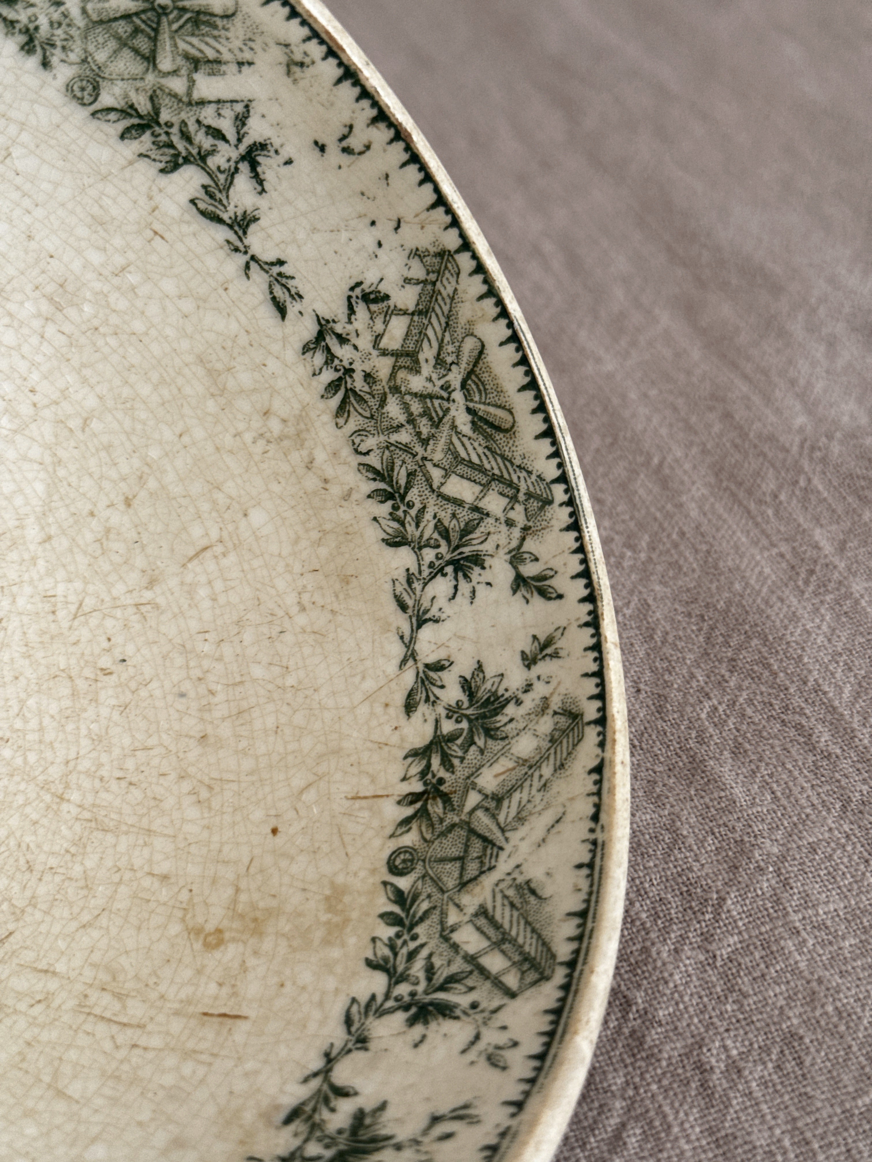 Close view of the interior rim border and the crazing in the cream glaze