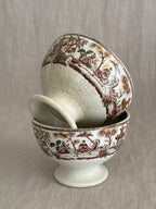 The pair tipped to show the printed bands and the pedestal feet