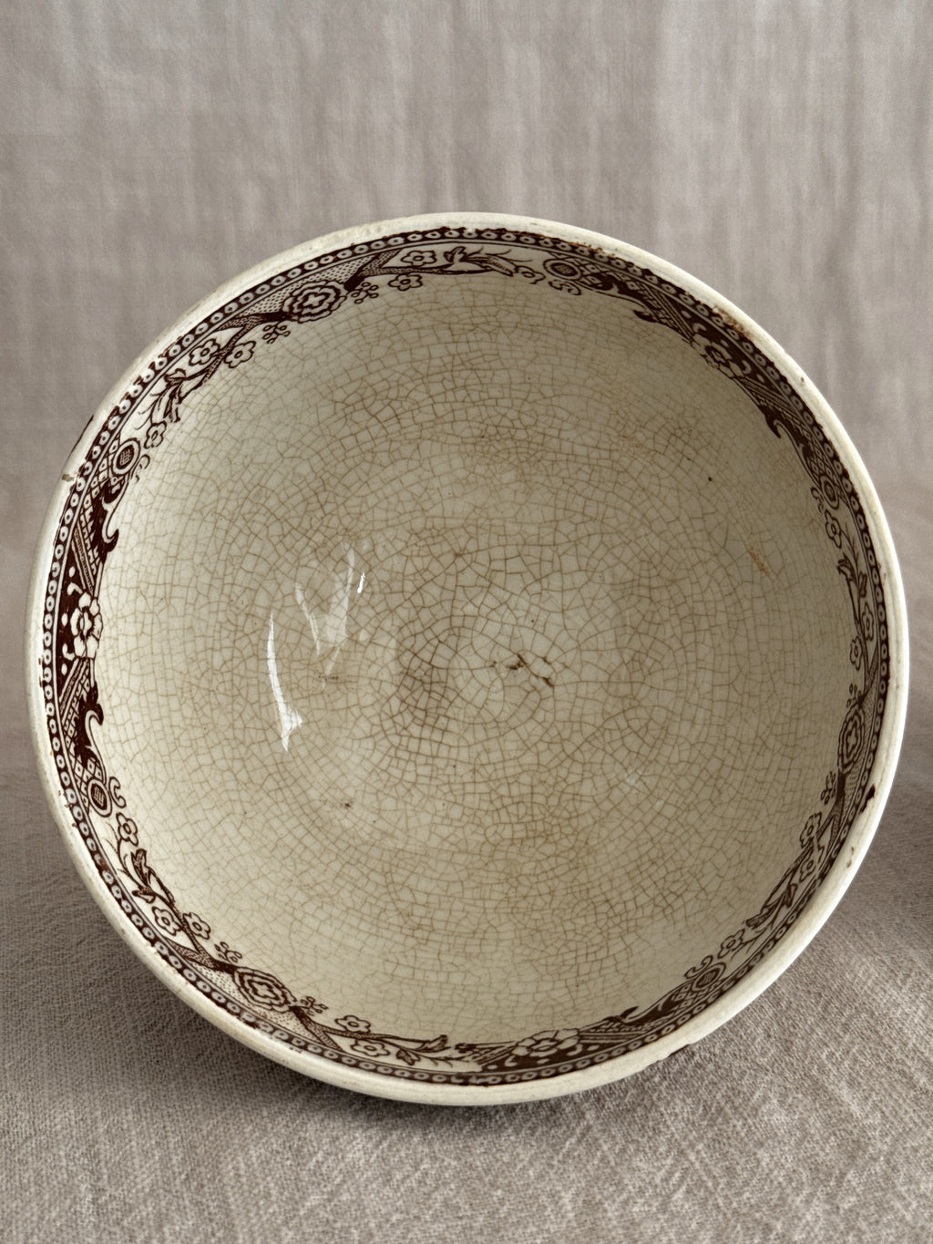 Looking into one bowl showing the brown printed border and heavy crazing