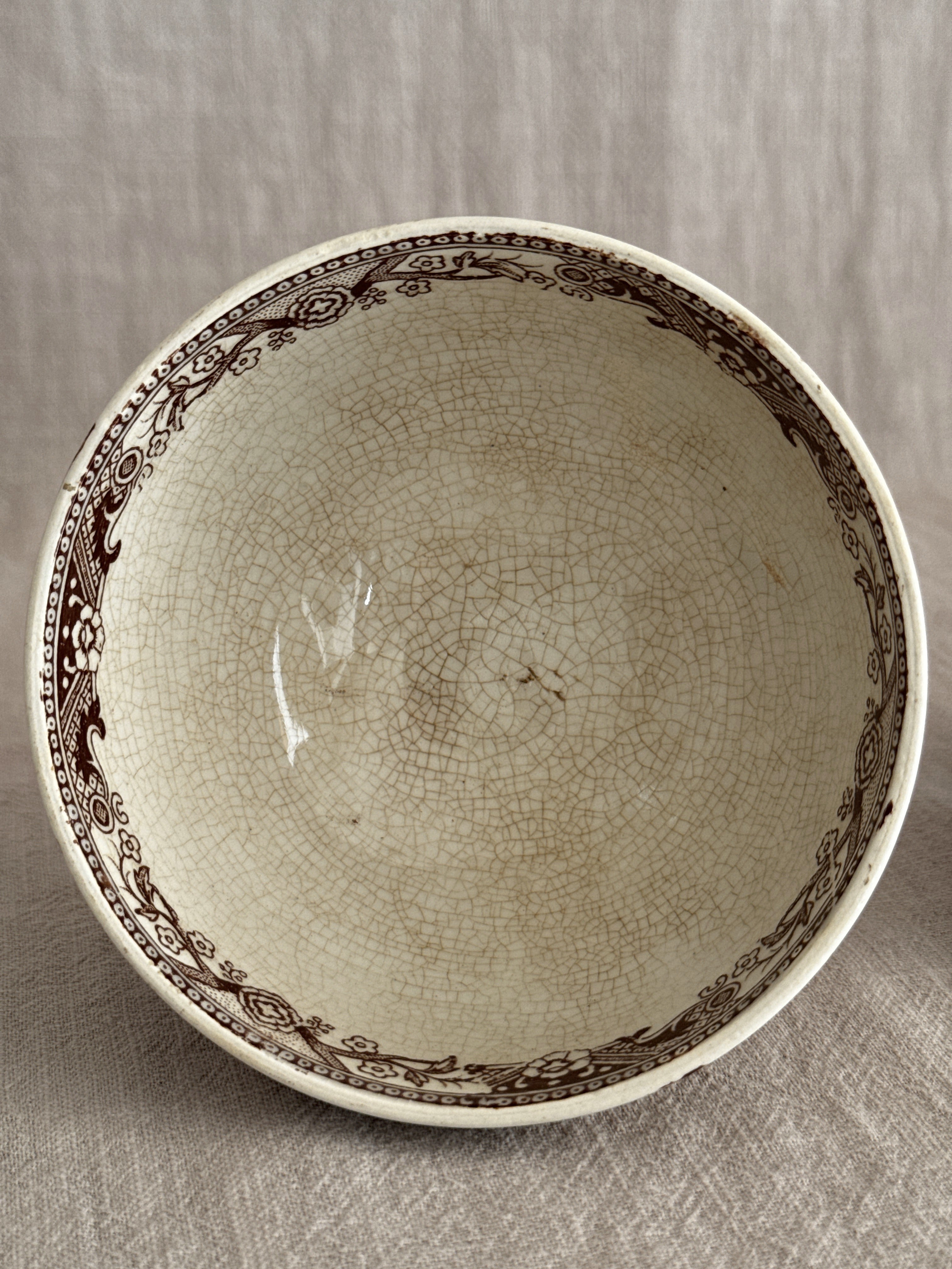 Looking into one bowl showing the brown printed border and heavy crazing