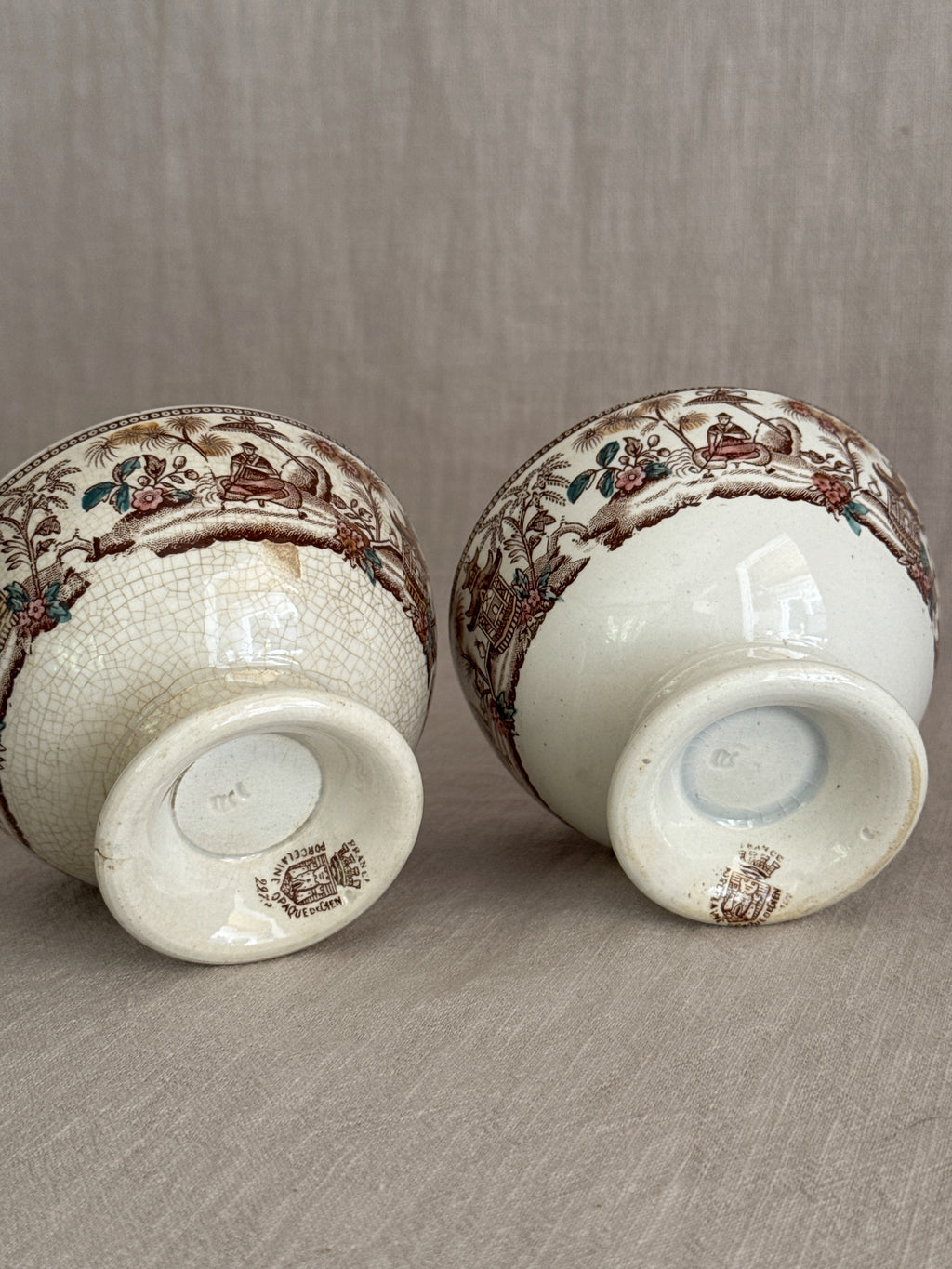 Undersides of the pair showing the printed PORCELAINE OPAQUE marks with crowned cartouche and FRANCE