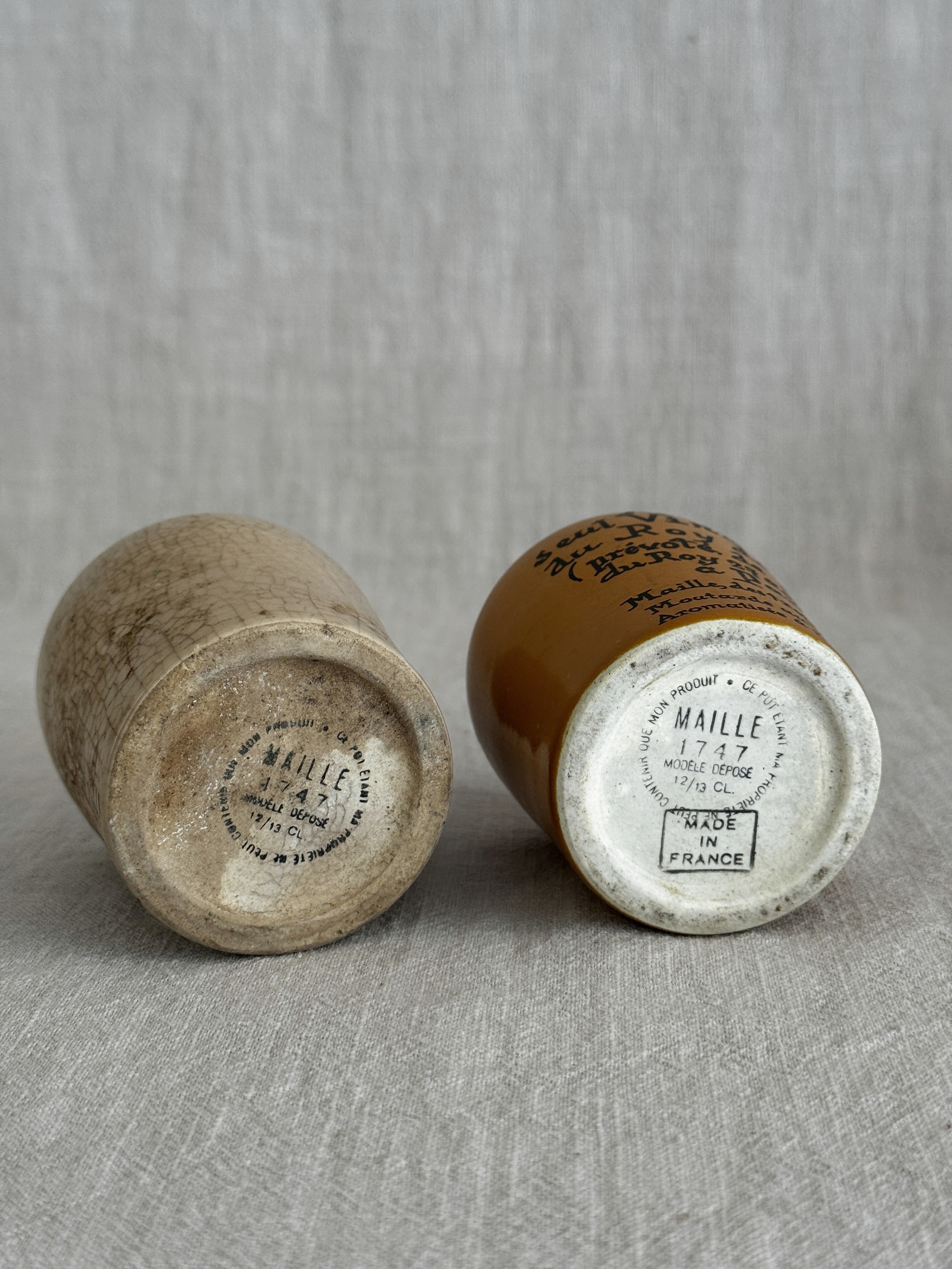 Both pots tipped to show their bases and printed capacity marks together