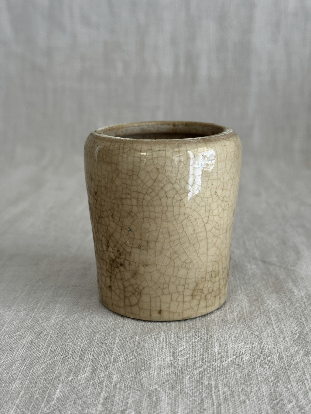 The cream pot standing alone, showing the even crazing across the unglazed body