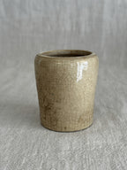 The cream pot standing alone, showing the even crazing across the unglazed body