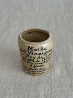The cream Maille pot photographed close, showing the crisp printed text and patina