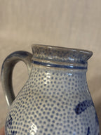 Close view of the pinched pouring lip and cobalt band at the collar