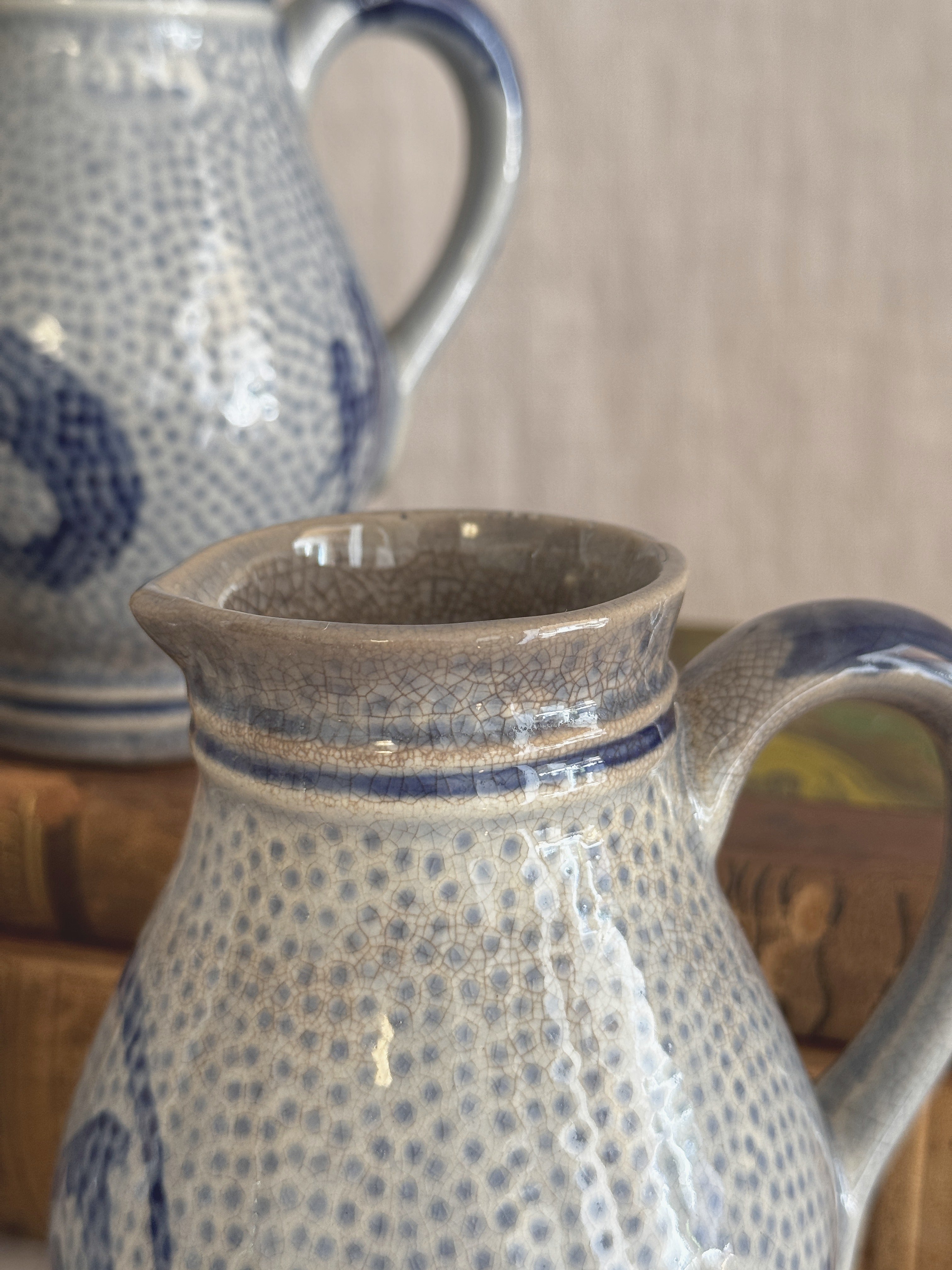 Close view of the open rim and grey glazed interior of one jug
