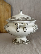 Side view of the antique Swedish tureen showing the pierced rosette handle terminals and deep crazing
