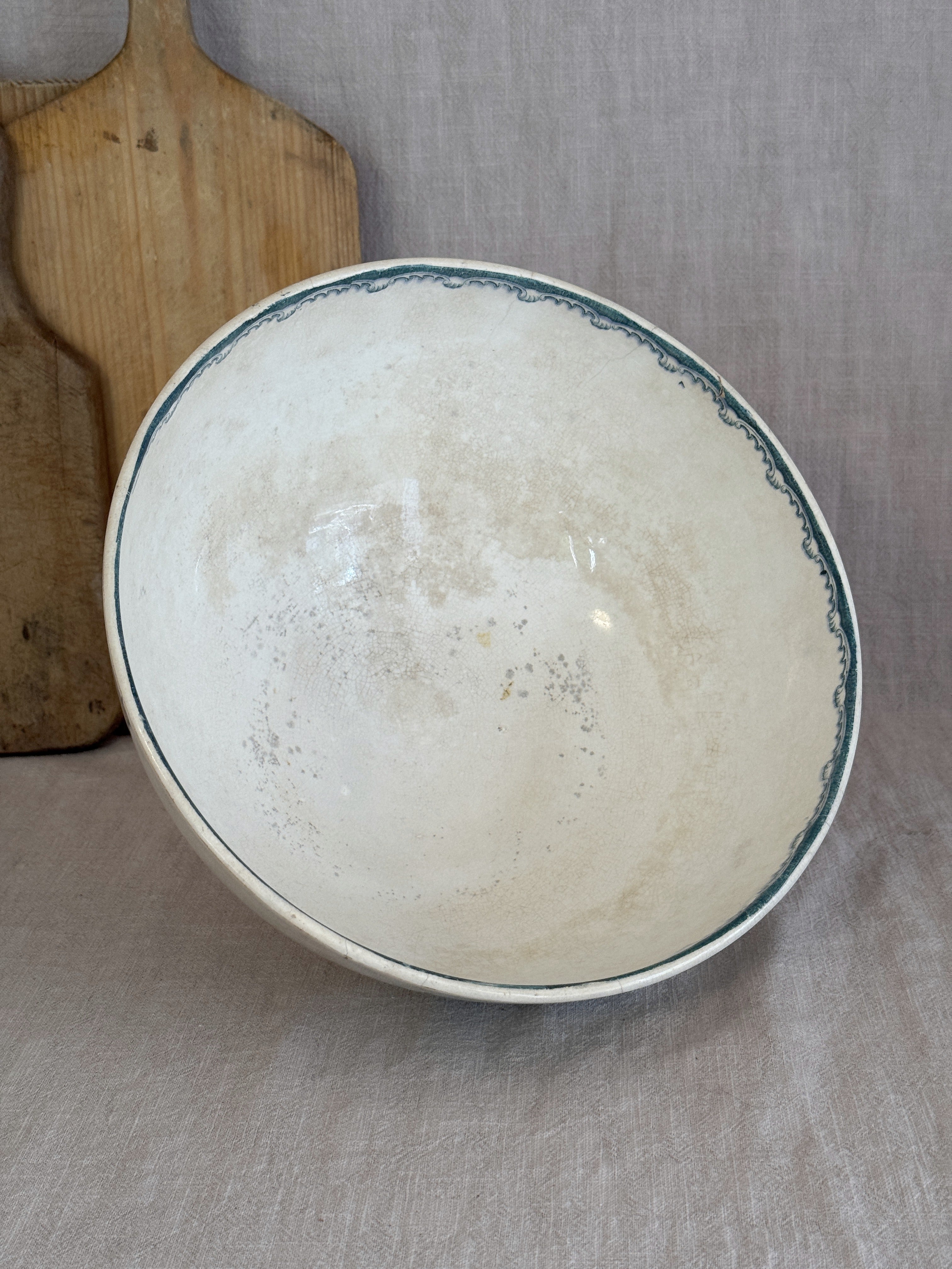 Interior of the antique Anna bowl, showing even crazing and warm tea-toned age spots across the glaze