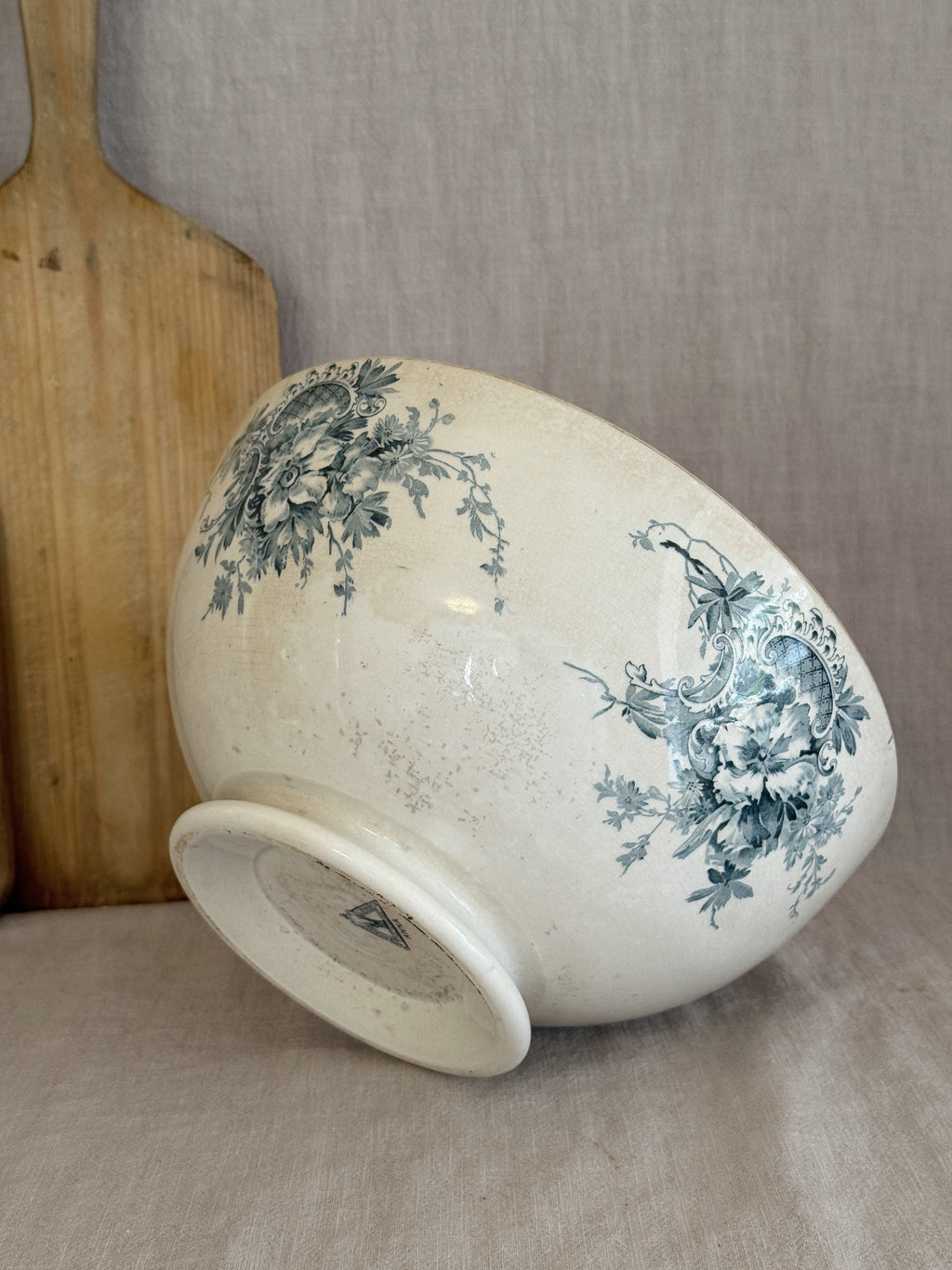 Antique Swedish flintware bowl tilted to show the low trumpet foot and the printed factory mark underneath