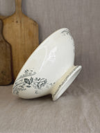 Antique French Pornic saladier in sage green transferware, tilted to show the beaded foot and floral transfer