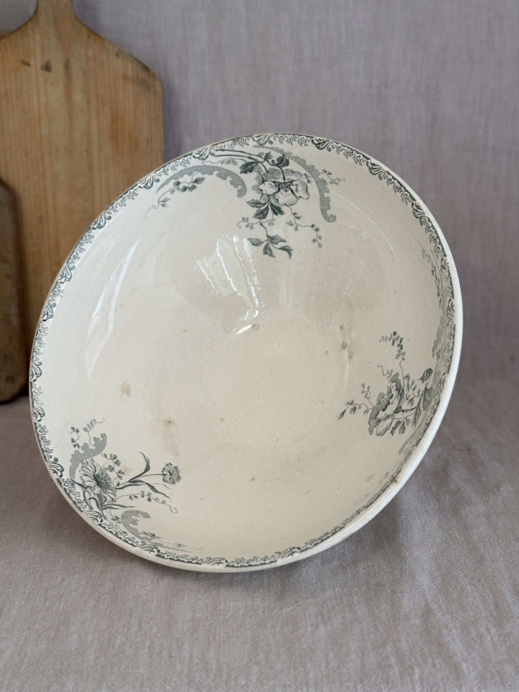 Interior of the French terre de fer salad bowl, printed with sage green roses and rocaille scrolls