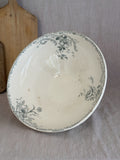 Interior of the French terre de fer salad bowl, printed with sage green roses and rocaille scrolls