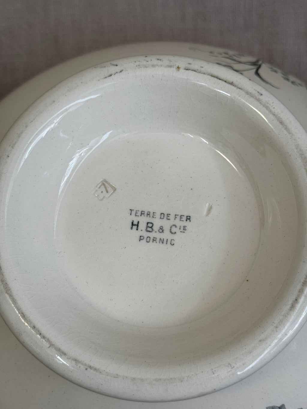 Close-up of the impressed lozenge mark and the printed H.B. & Cie Pornic stamp on the base