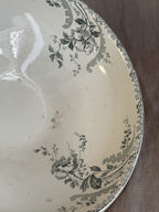 Interior rim of the antique terre de fer saladier, showing the scrolled border and floral transfer