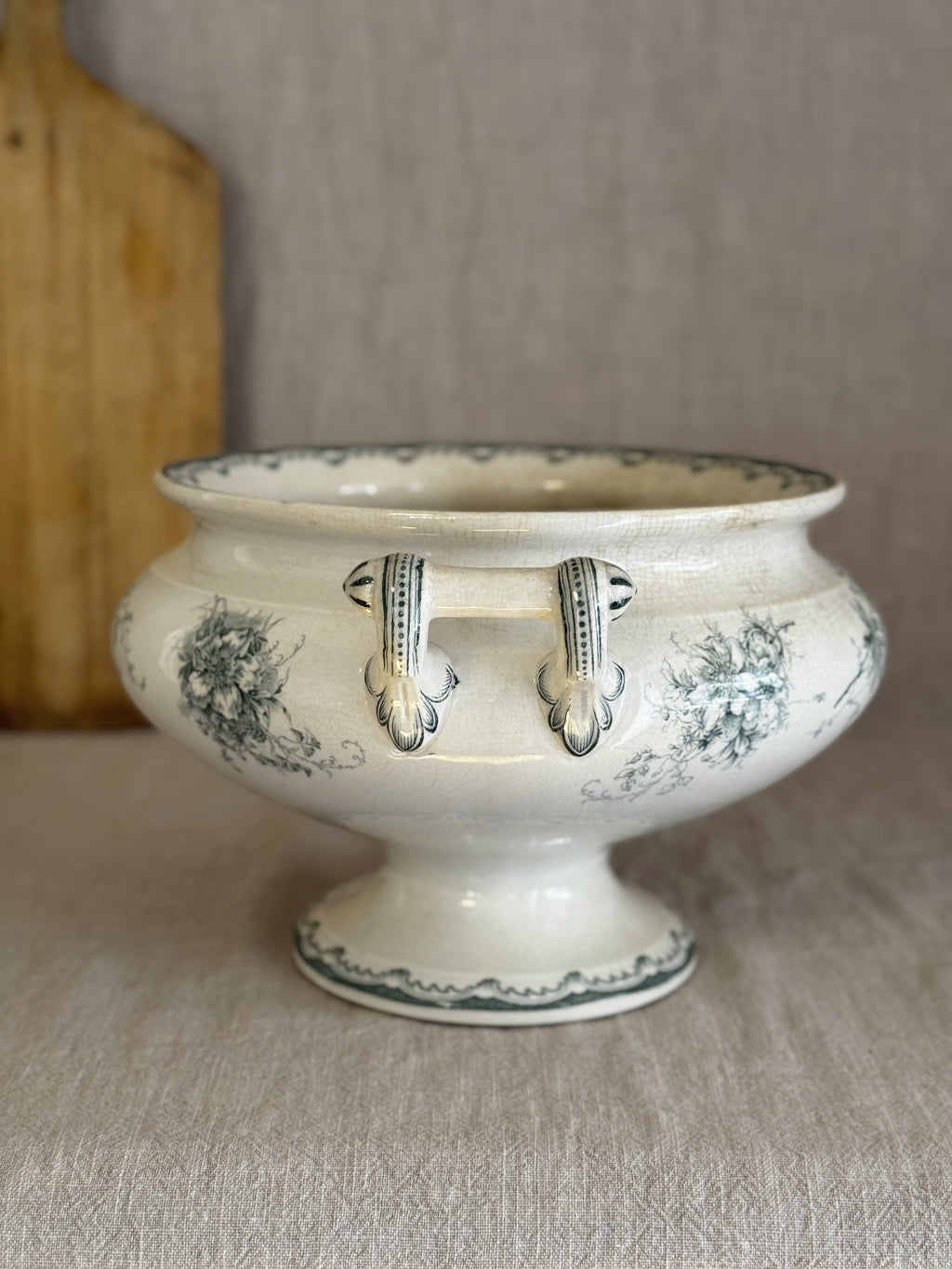 Antique Anna pedestal bowl seen end-on, showing both hand-painted scrolled handles