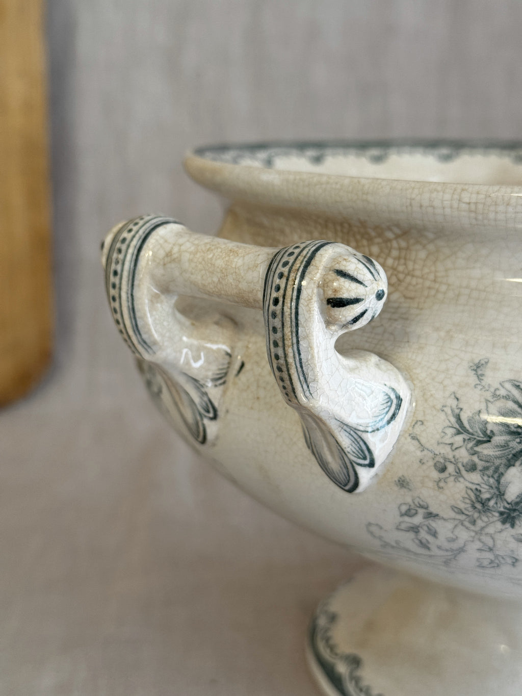 Close-up of the hand-painted handle on the antique Swedish pedestal bowl, with dot rows and leaf scales