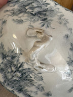 Branch finial with four metal staples on the teal floral transferware lid