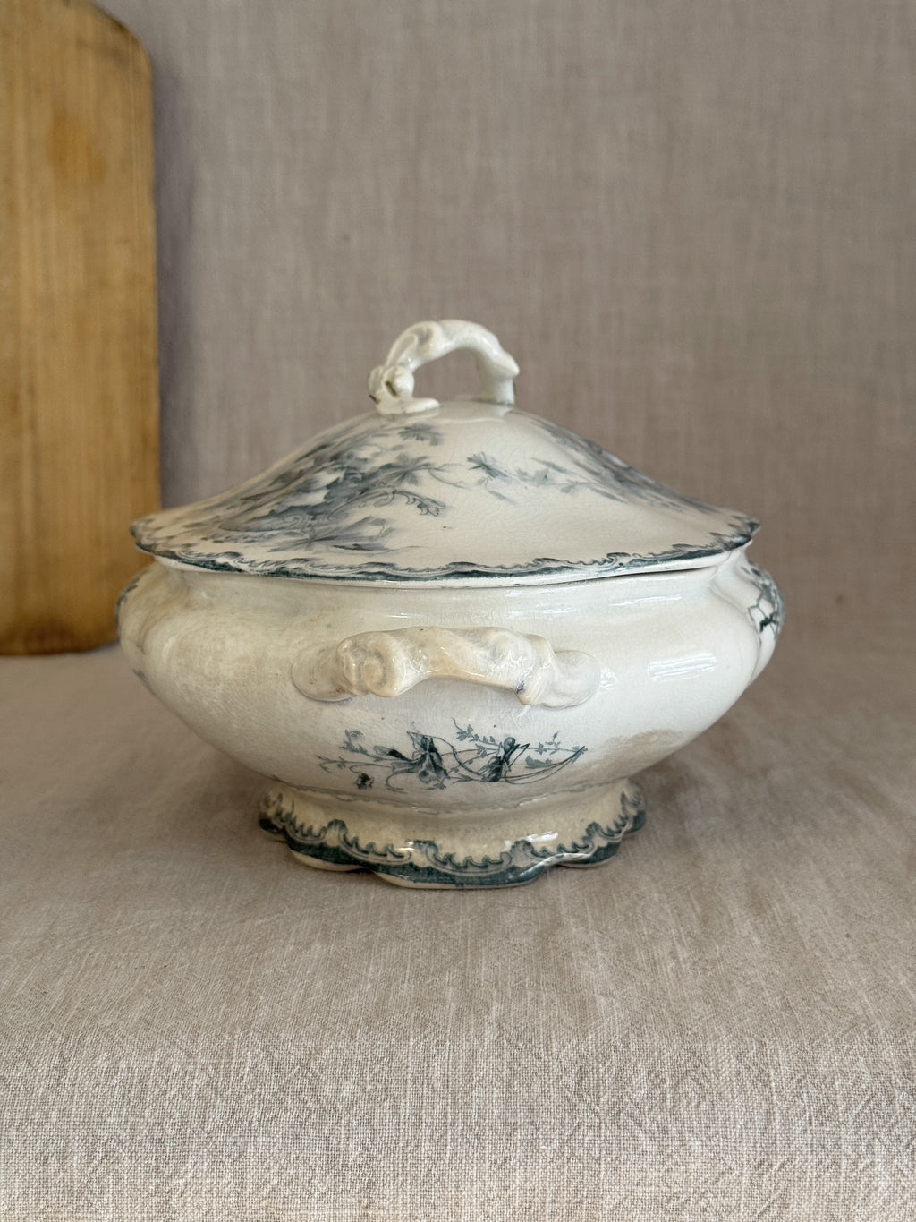 Low oval Swedish transferware tureen seen from the end, lid and branch finial in view