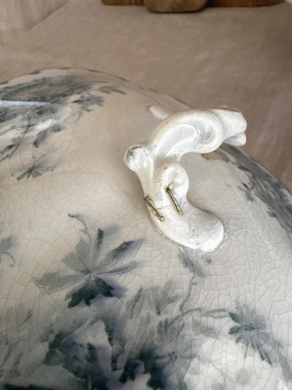 Detail of the antique staple repair to the lid handle of the Swedish Anna tureen