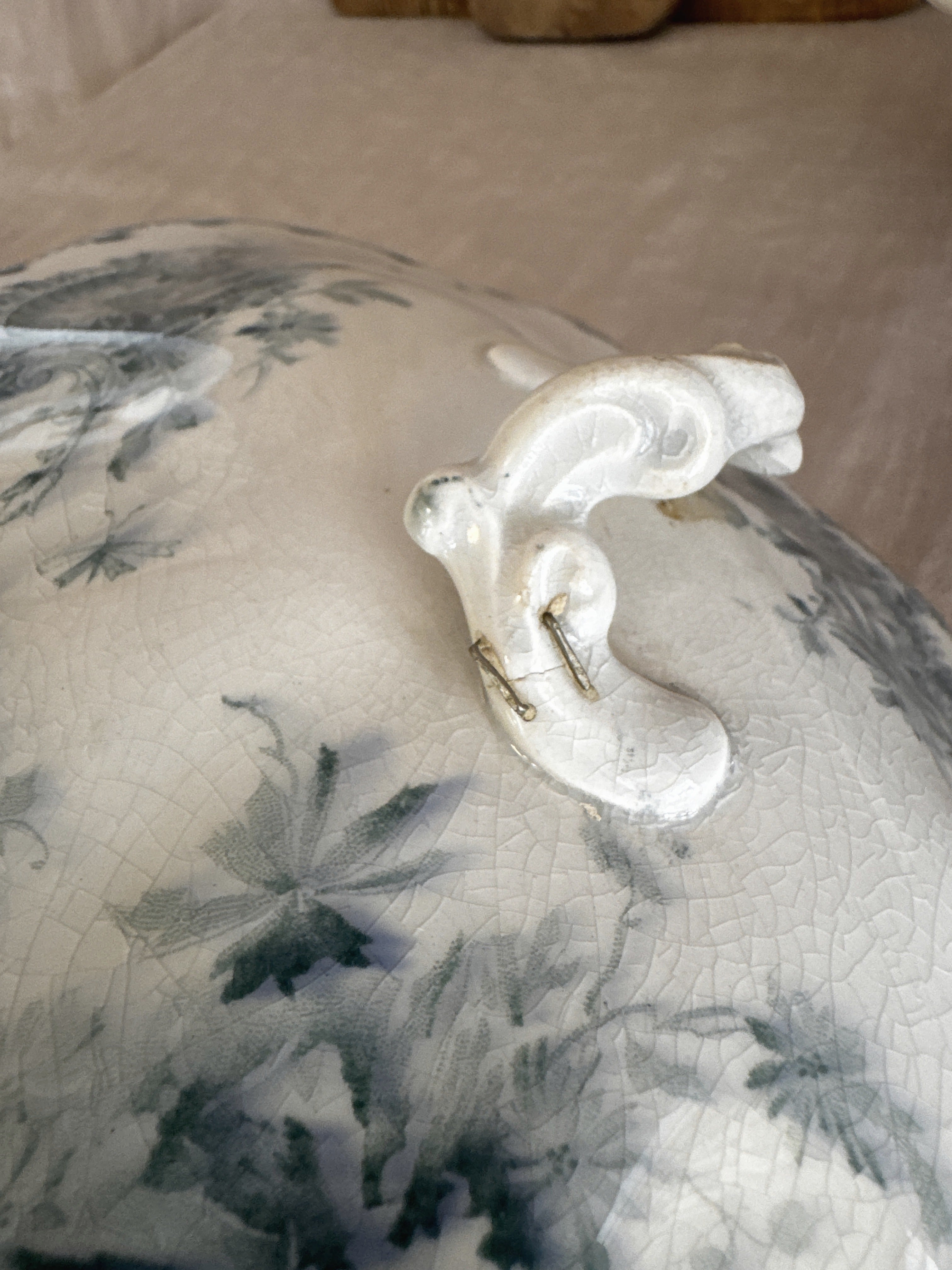 Detail of the antique staple repair to the lid handle of the Swedish Anna tureen