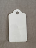 Antique white faience board with moulded rococo shell relief and hanging hole, glazed front, on linen
